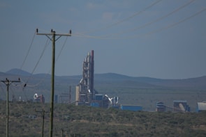Wide shot of a power plant facility showcasing extensive insulation work on boilers and ducts