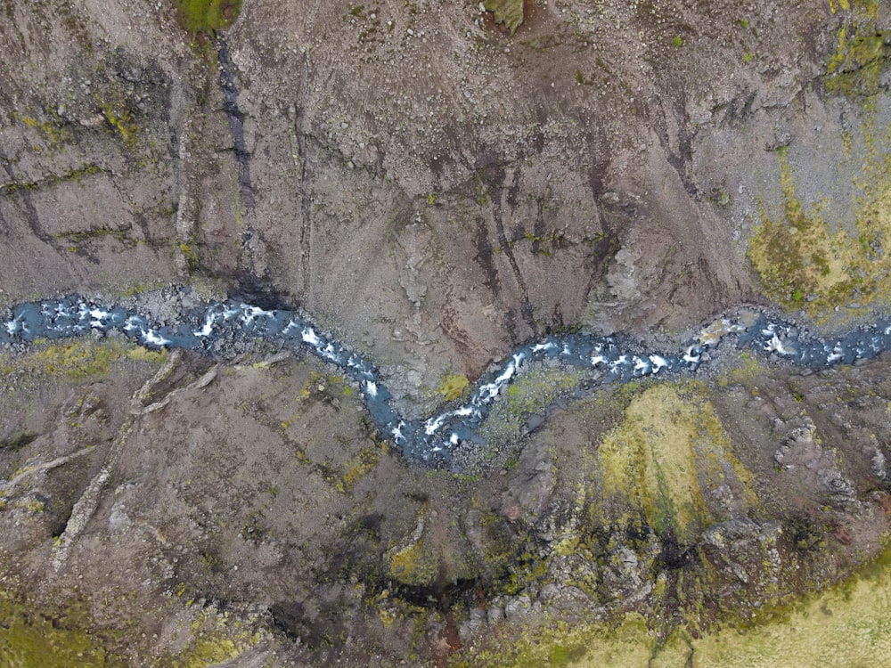 a stream of water running through a rocky area