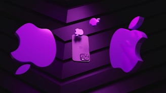 A stylized representation of multiple iconic apple logos and a smartphone, all depicted in a bright purple hue. The objects are arranged against a dark, striped background, creating a stark contrast and highlighting the vibrant color of the apples and the phone.