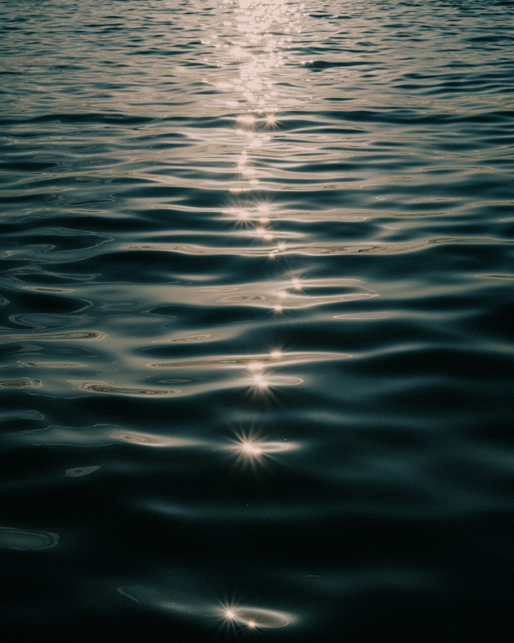 a body of water with light shining on it
