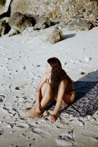 a person sitting on the sand
