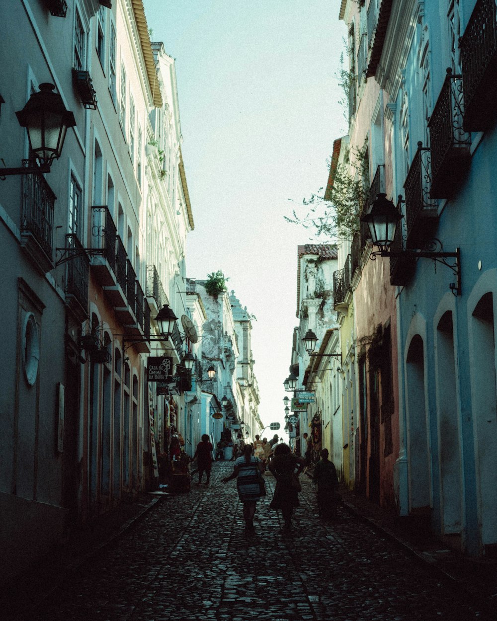 people walking down a narrow street