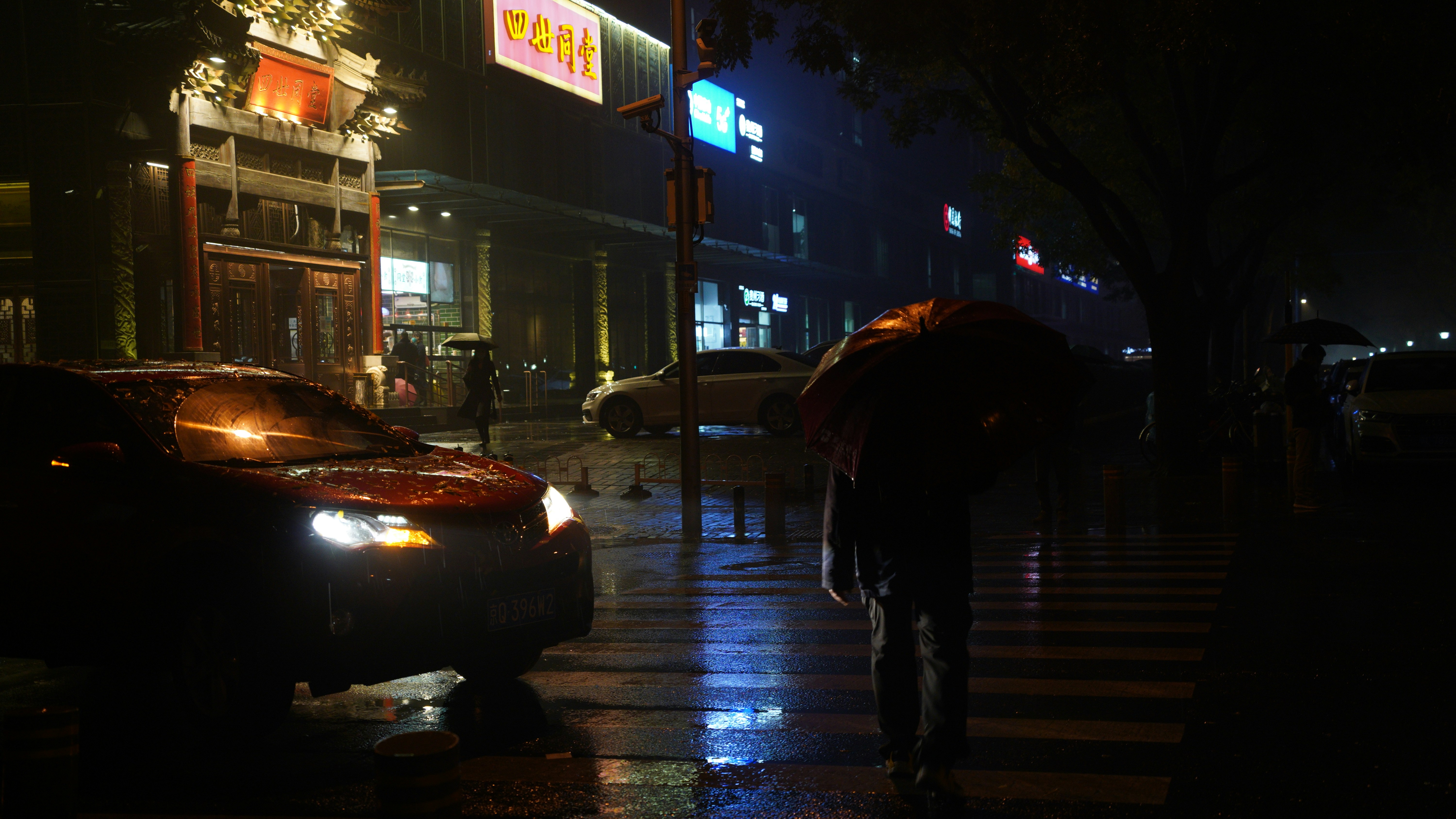 a person walking down a sidewalk with an umbrella