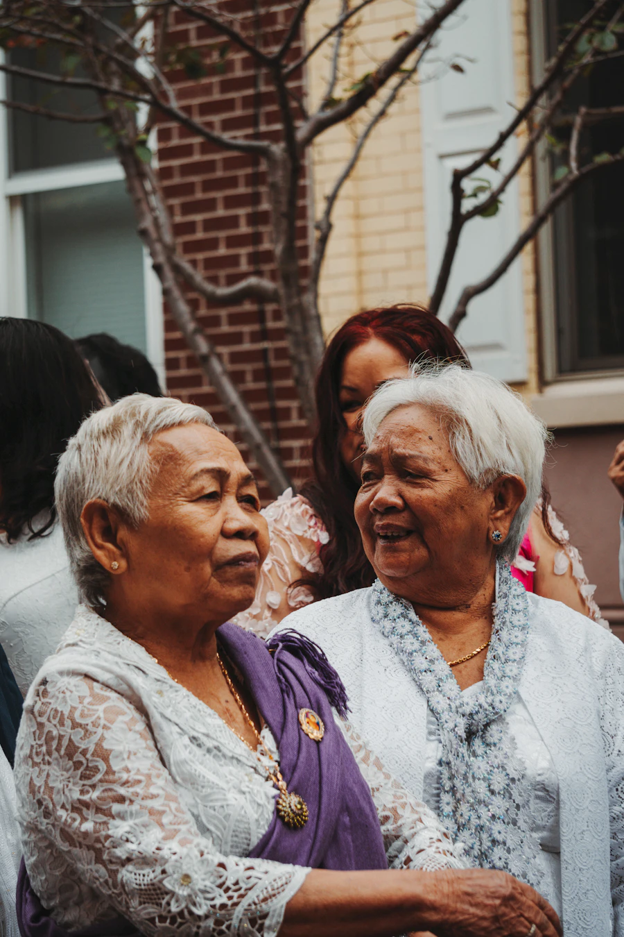 A mother and her adult daughter smiling together in the afternoon light