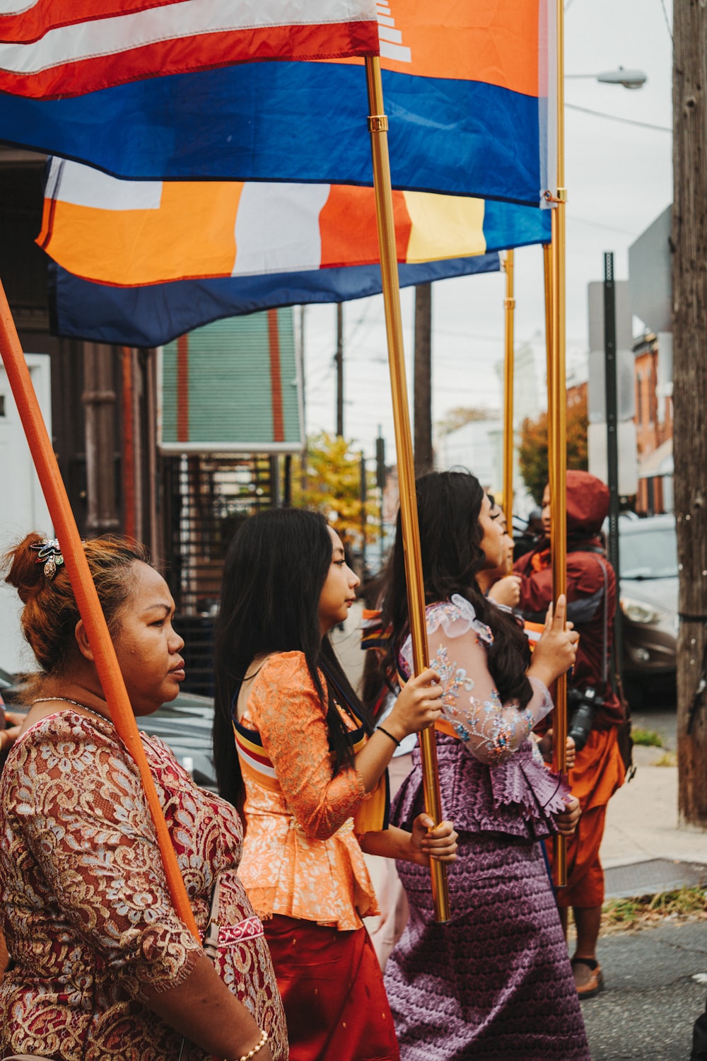 a group of people stand under an umbrella