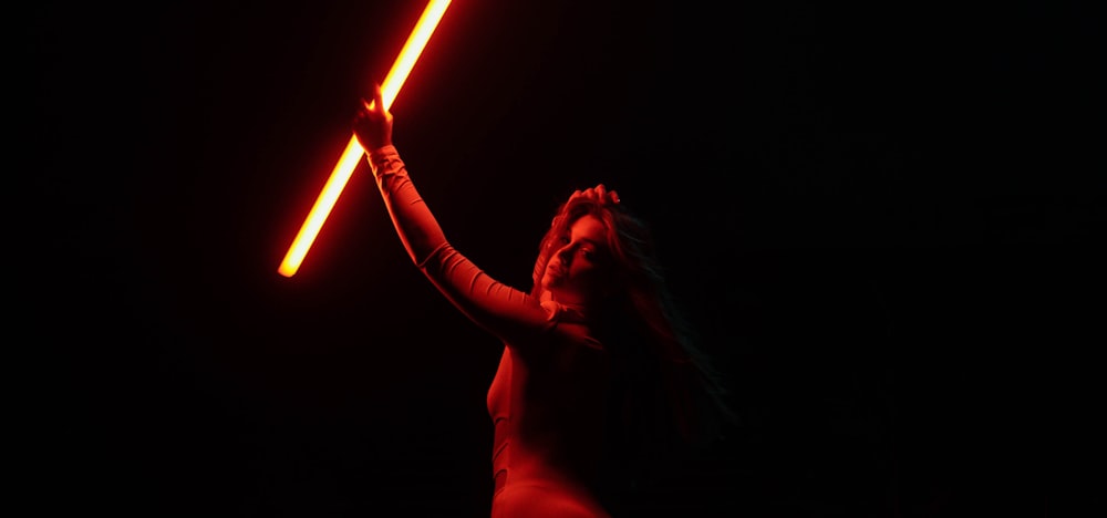 a person holding a light saber