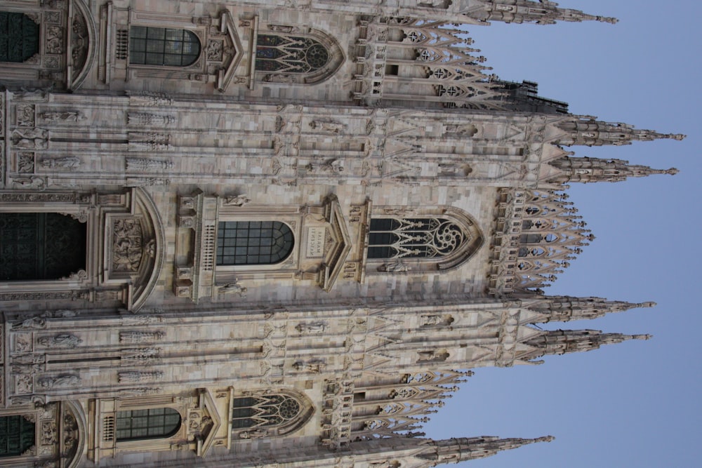 a large stone building with Milan Cathedral in the background