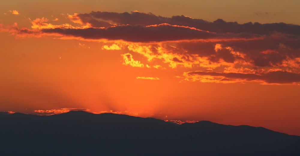 a sunset over a mountain range