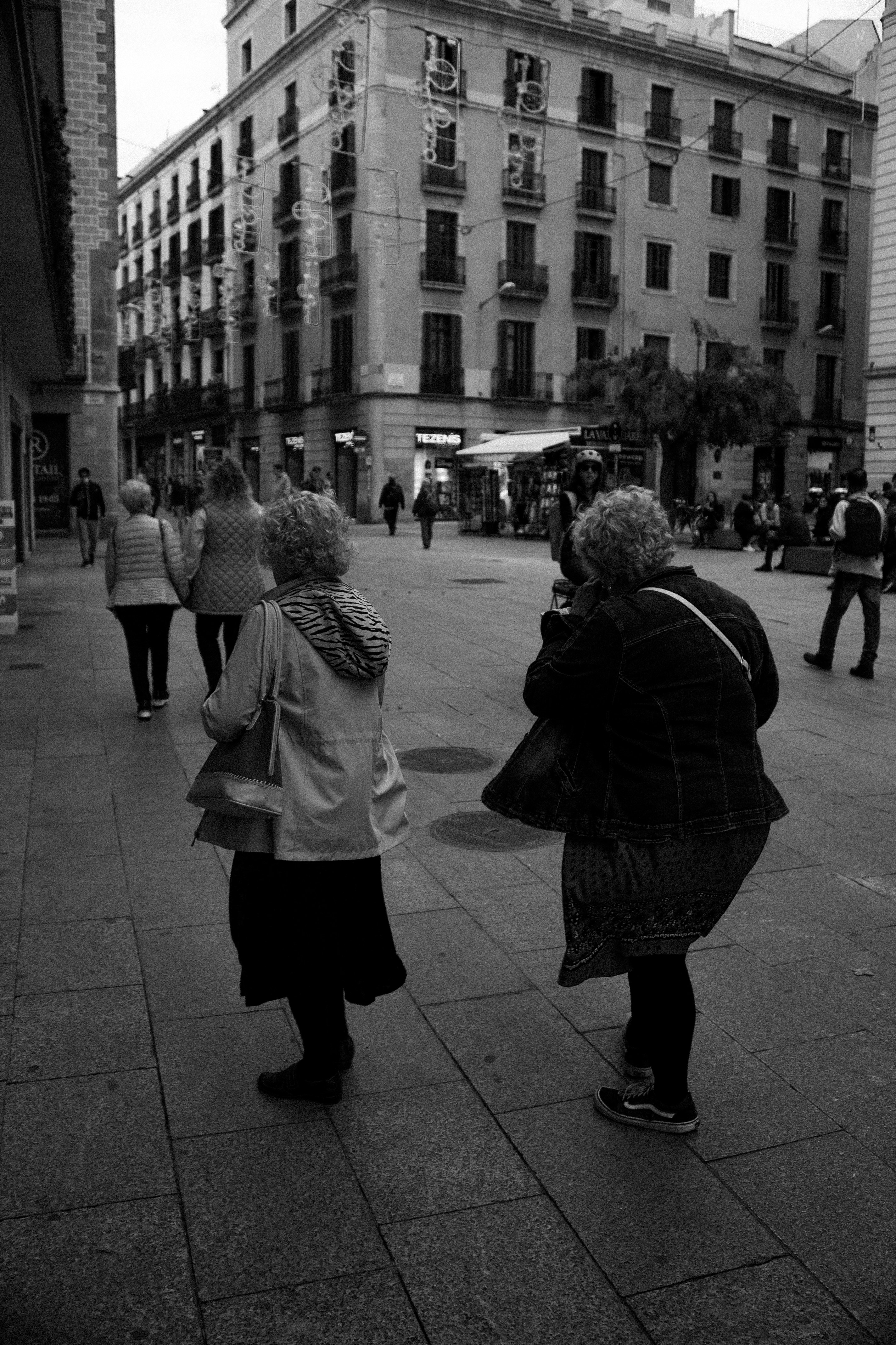 a group of people walking on a sidewalk
