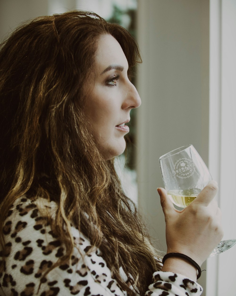 a woman drinking from a glass