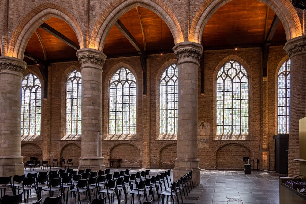 a room with rows of chairs and large windows