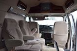 Interior view of a clean, spacious taxi van ready for family trips.