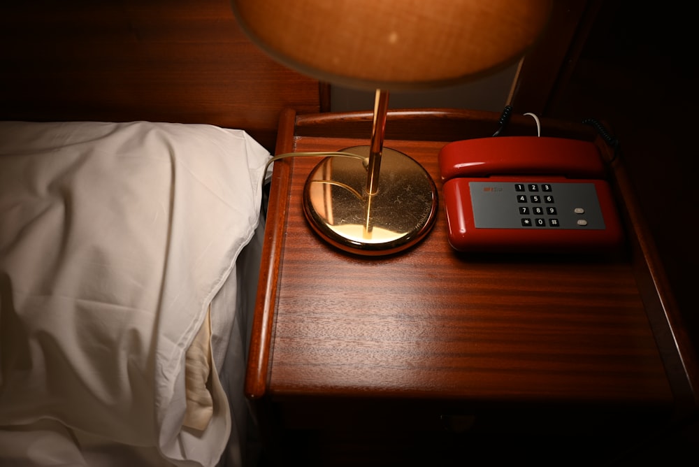 a table with a lamp and a phone on it