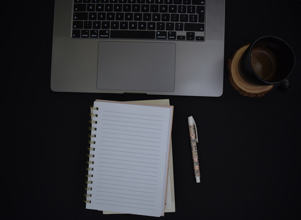 a notebook and a pen on a desk