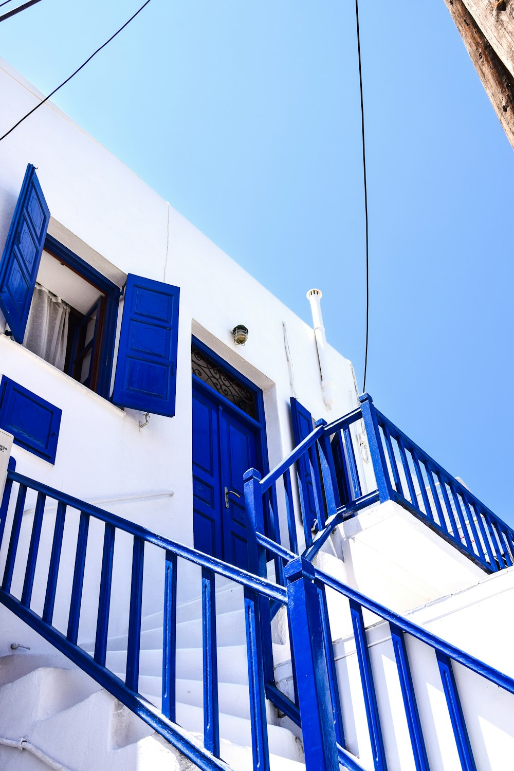 a white building with blue doors