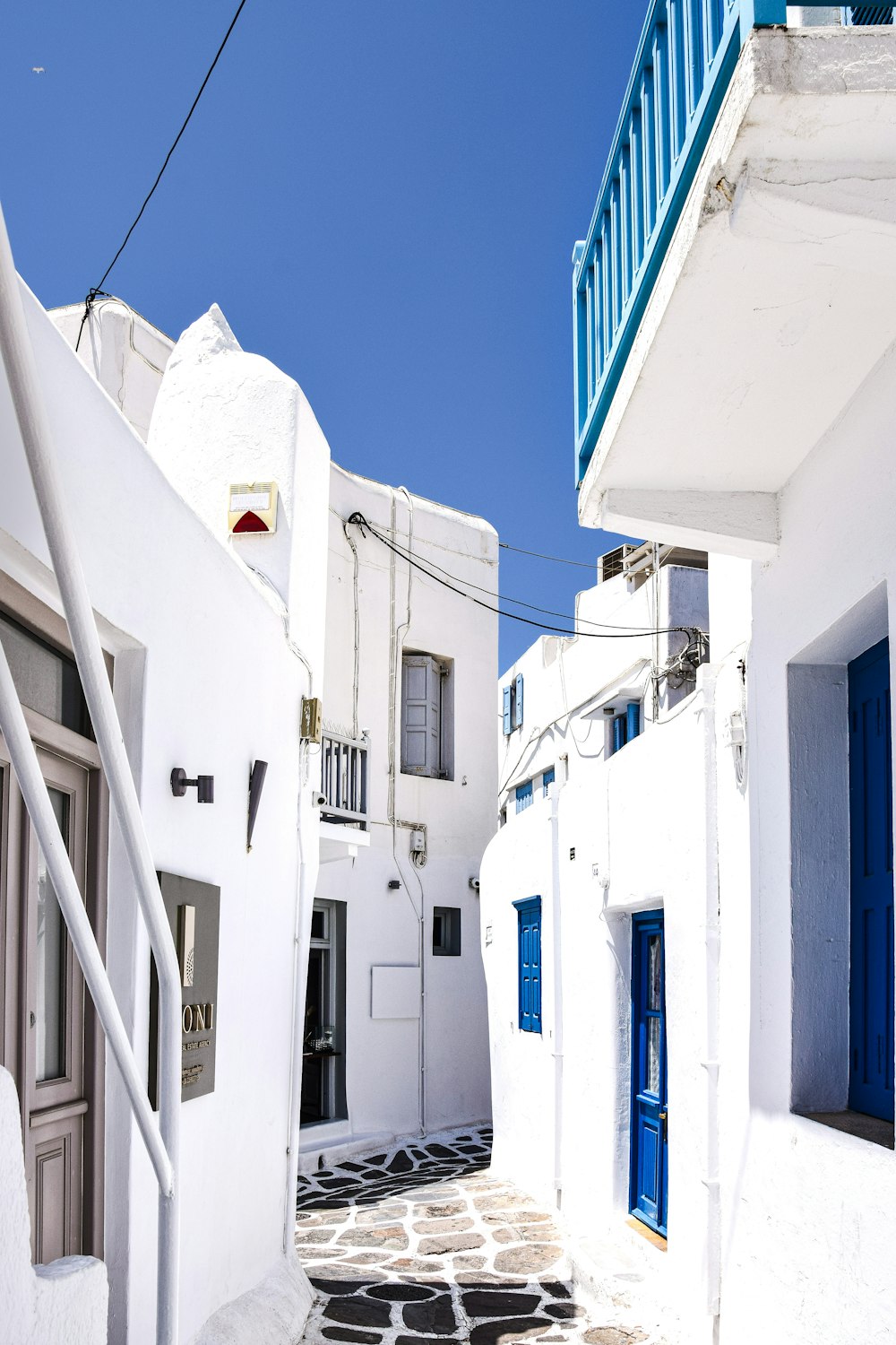 a narrow street with white buildings
