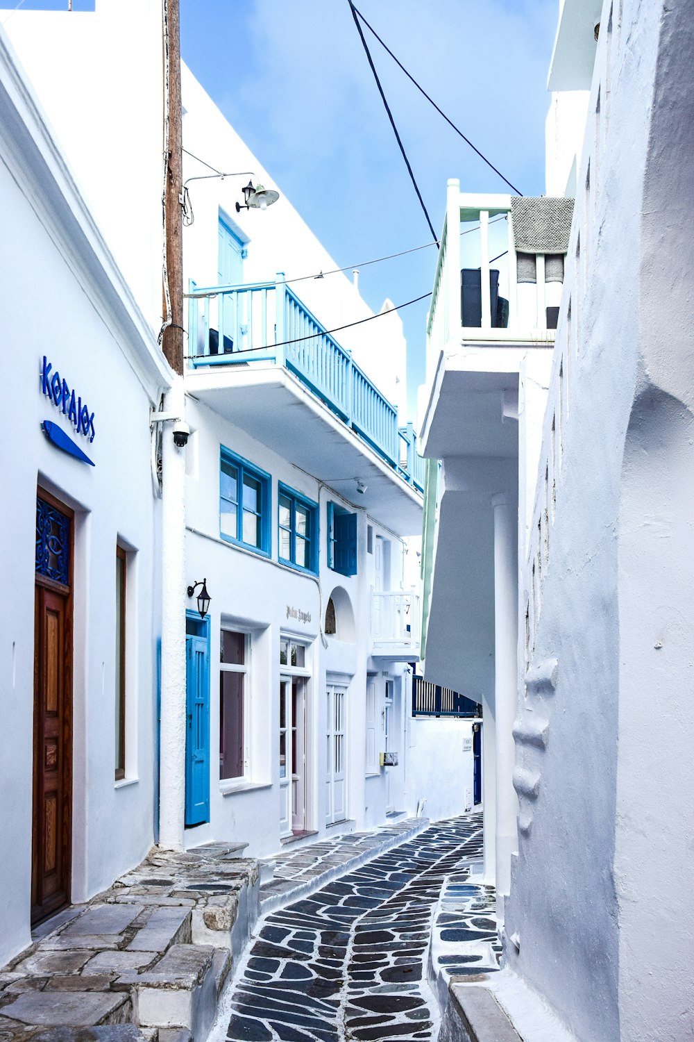 a narrow street with white buildings