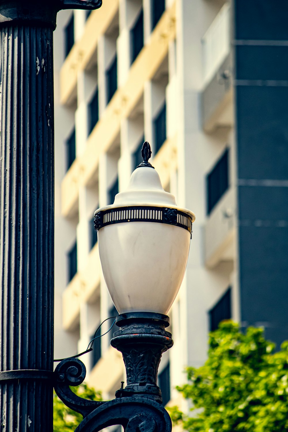 a lamp post with a building in the background