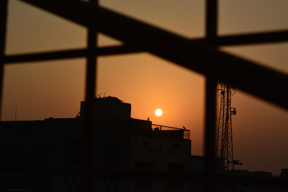 a silhouette of a building and a sunset