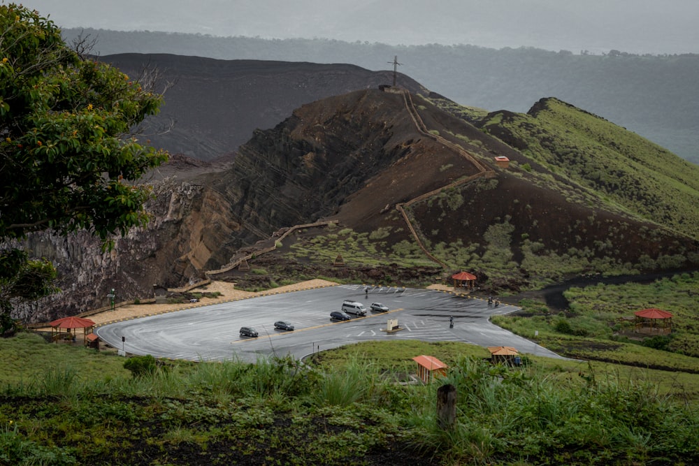 a road with cars on it next to a body of water