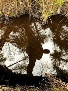 A person reflecting in nature, symbolizing personal growth.