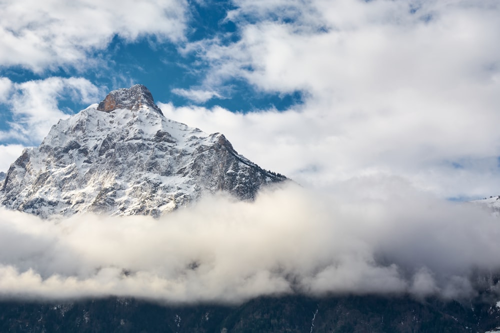 a mountain with clouds below