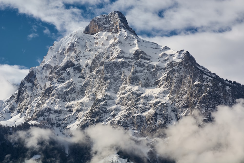 a mountain with clouds below