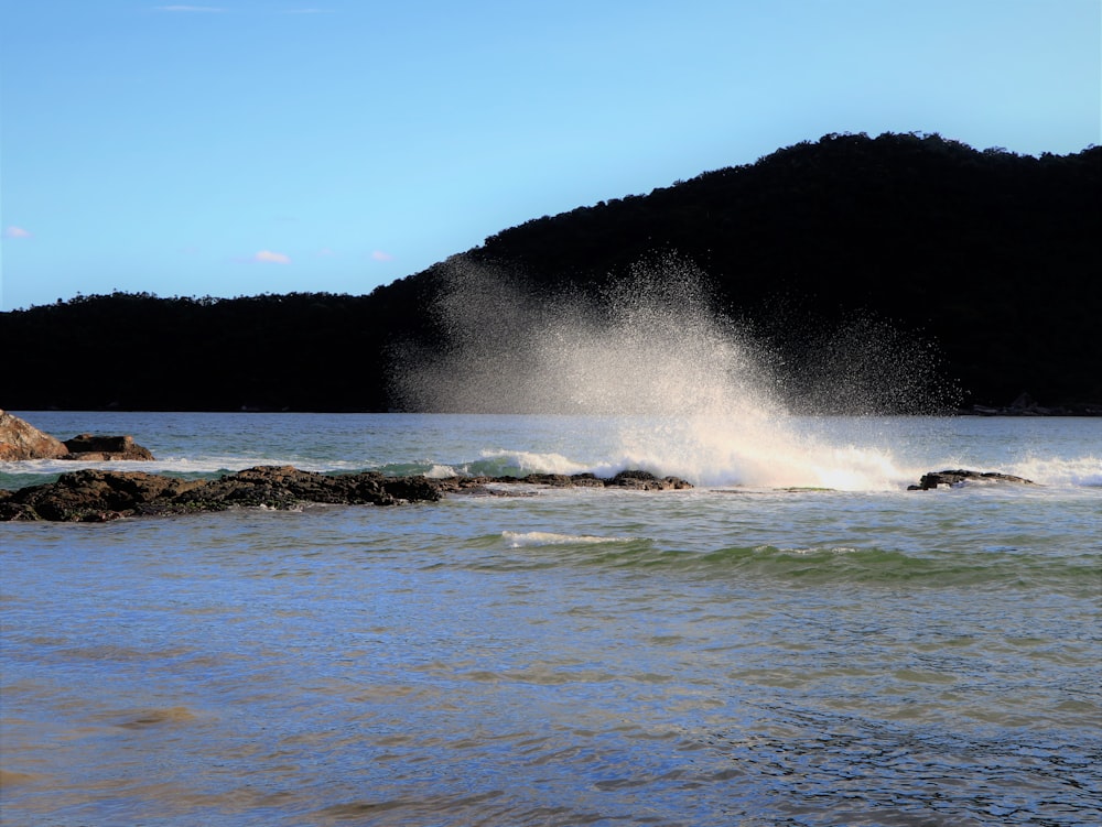 a body of water with waves crashing on it