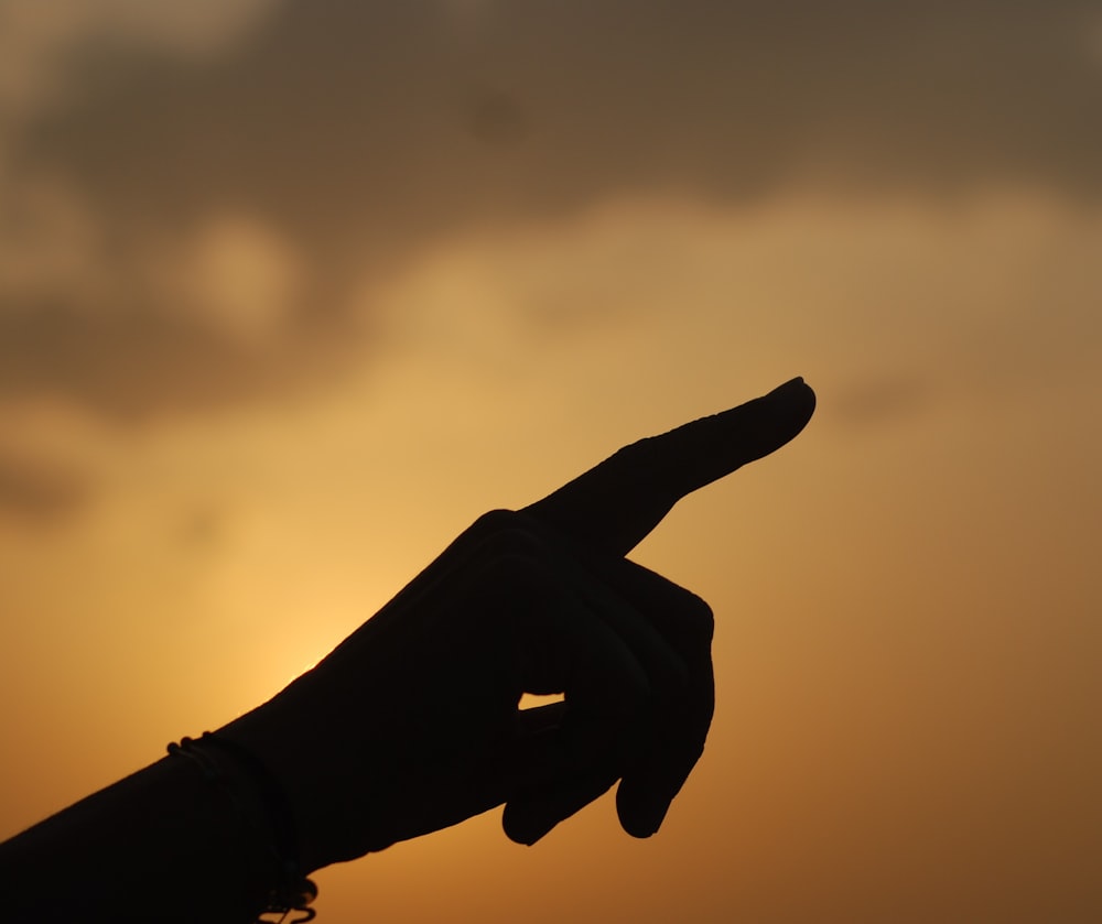 a hand holding a light bulb