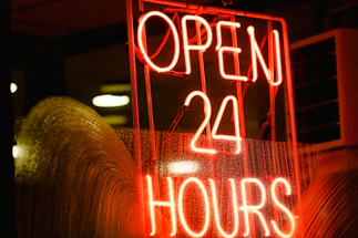 A welcoming office entrance with a glowing 24/7 open sign.