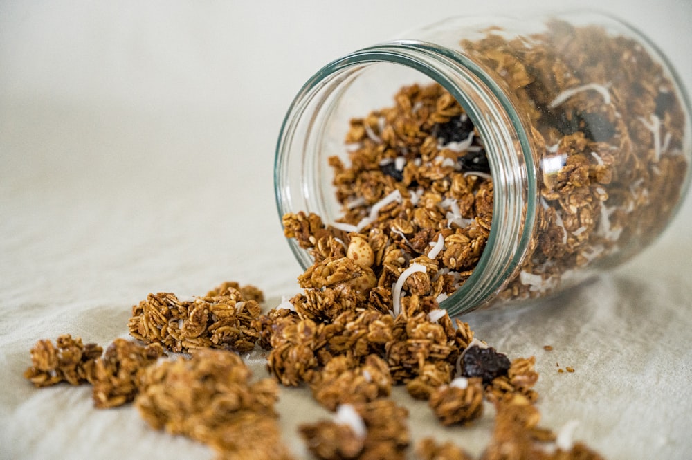 a glass bowl full of dried brown and white grains