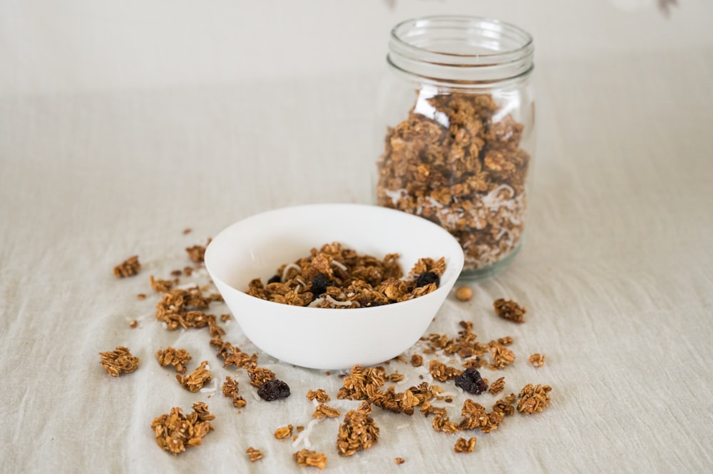 a jar of seeds and a bowl of seeds