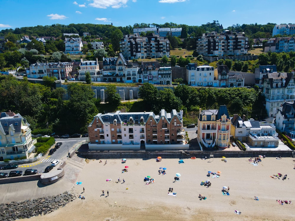 a beach with many people and buildings