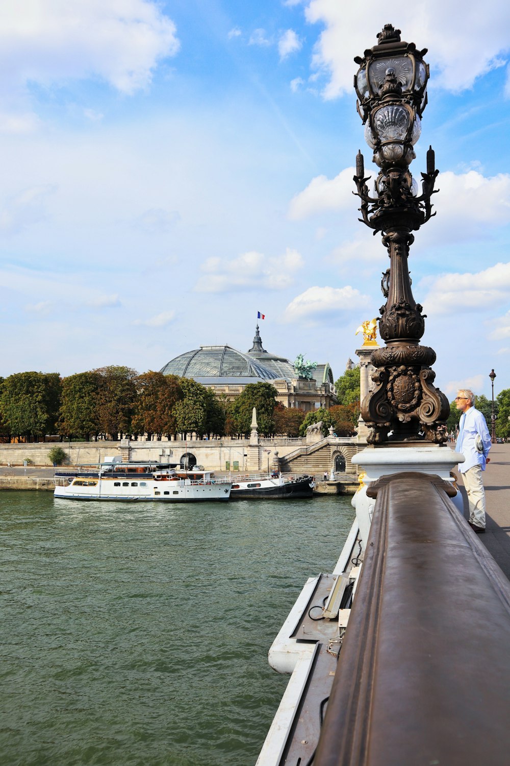 a person standing on a dock next to a body of water