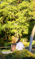 A serene portrait of a couple sharing a quiet moment in a sunlit park