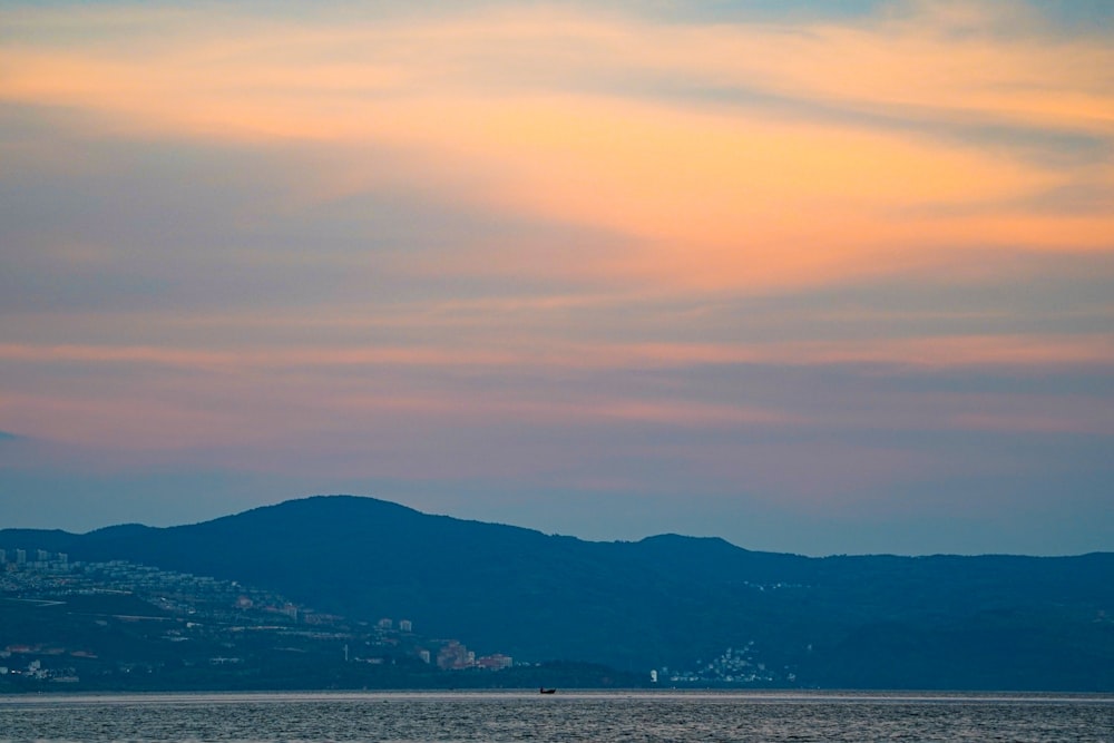 a body of water with a city in the distance