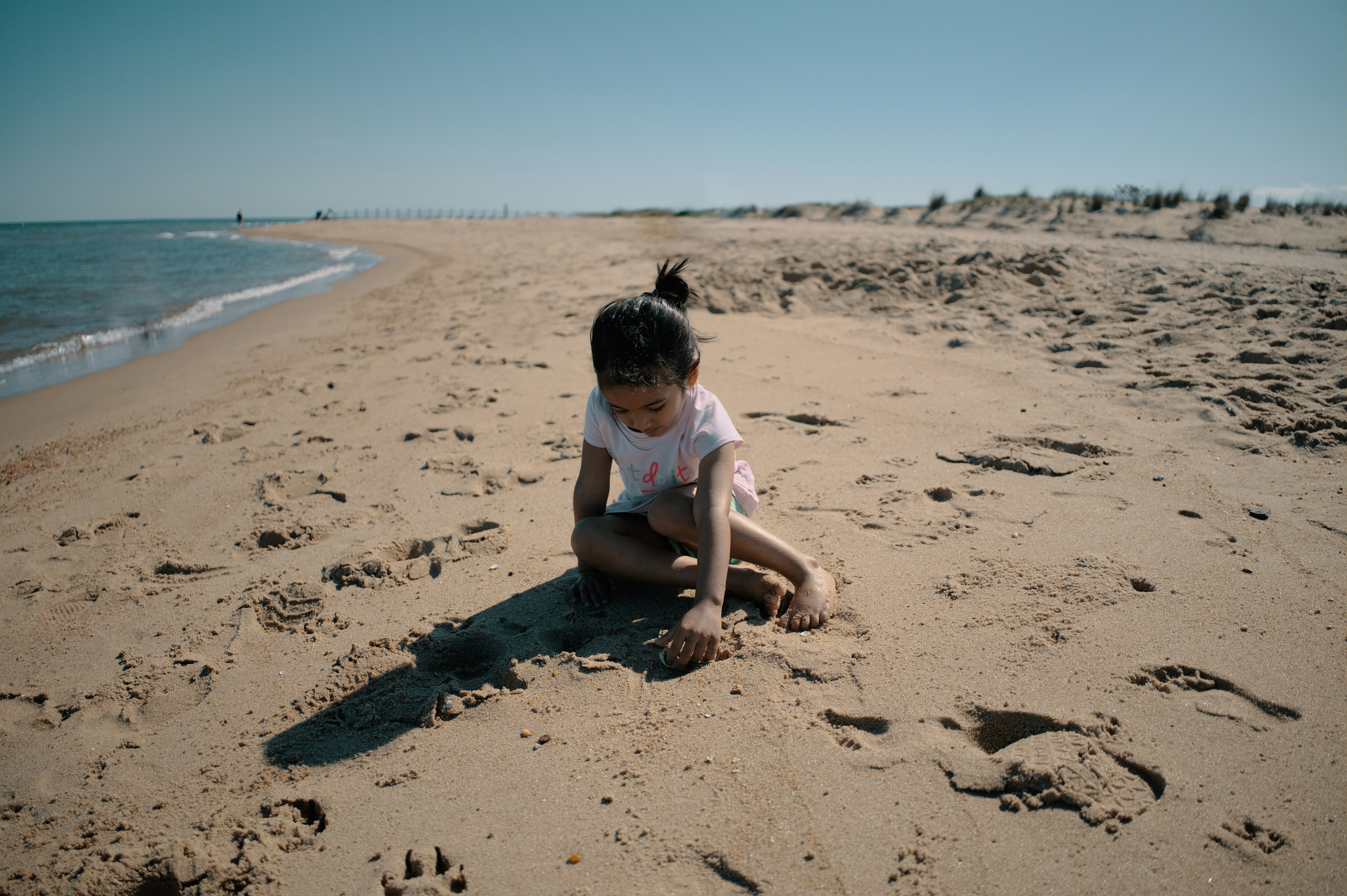Summer 22, Day 5 - My niece gets ready to build a sandcastle My sweet little niece Aditi Maya loves to wander in nature. She was very excited to play with sand. She was getting ready to build a sandcastle. After spending some time at the beach, we headed back to our camp site.