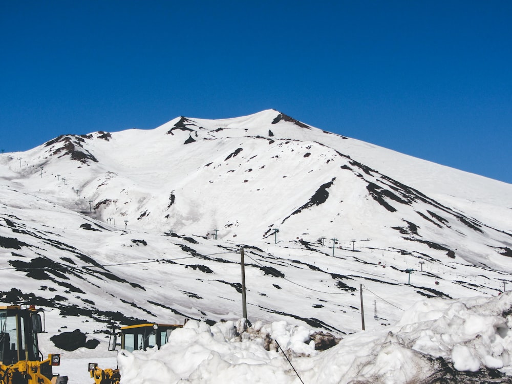 a snowy mountain with a building