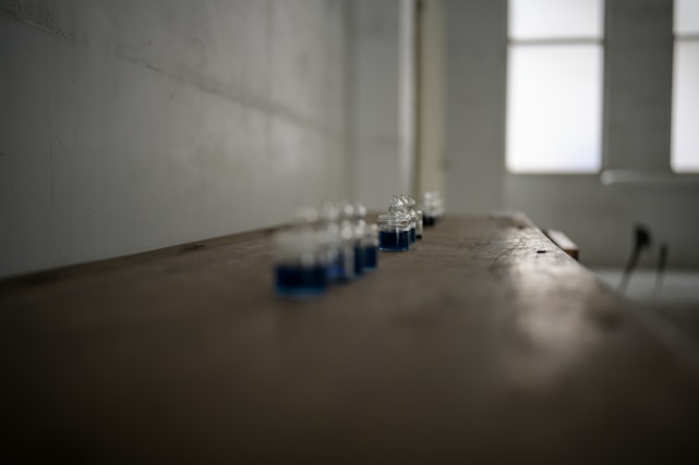 Close-up of clear organic chemical liquids in laboratory glassware with a soft natural light.