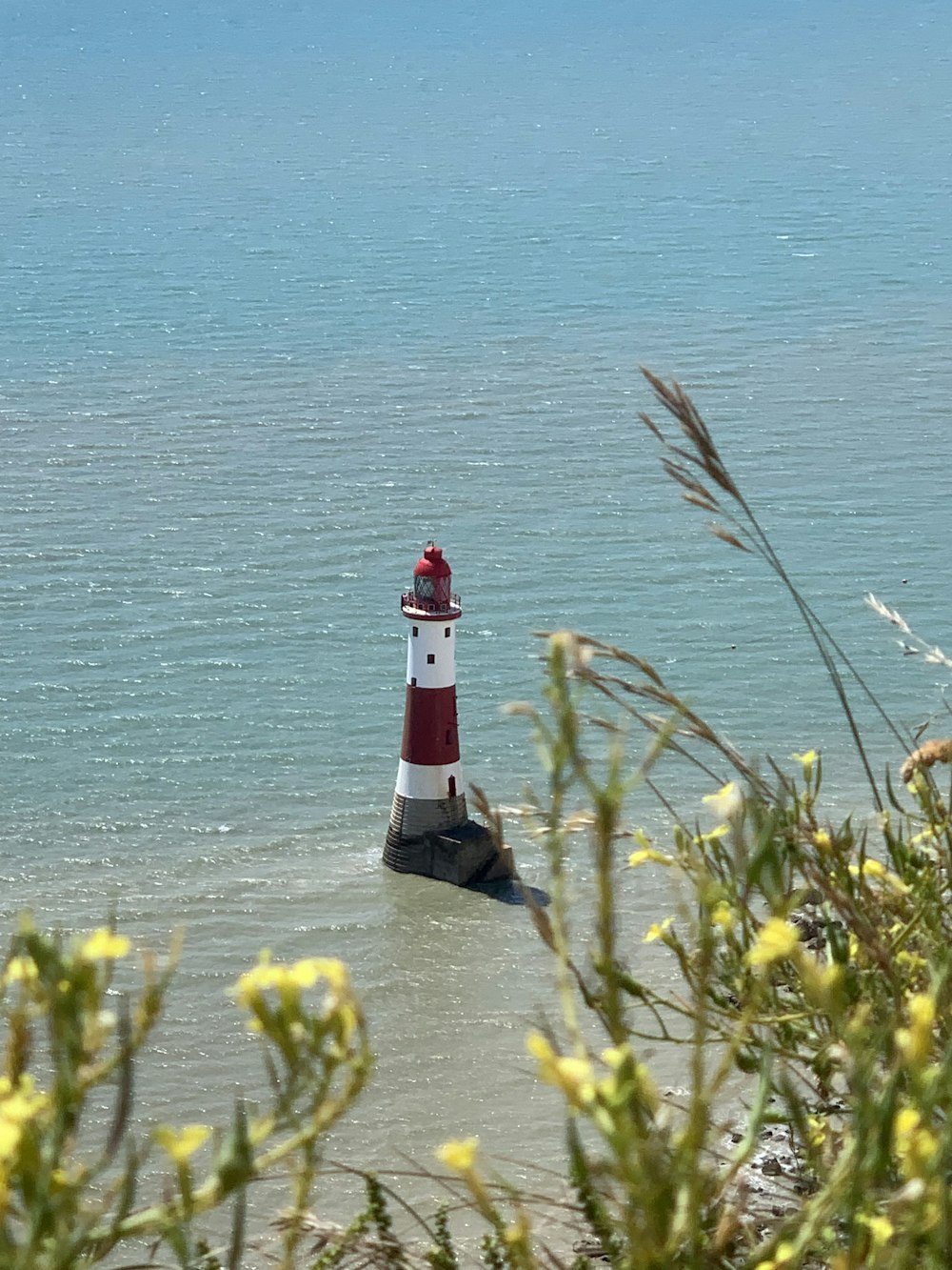 a lighthouse in the middle of a body of water