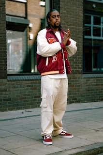a person wearing a red and white jacket and white pants retro