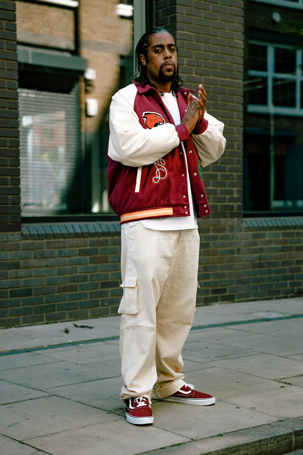 a person wearing a red and white jacket and white pants