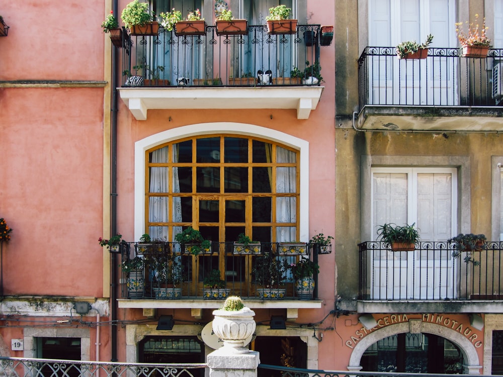 a building with a balcony and a statue in front of it