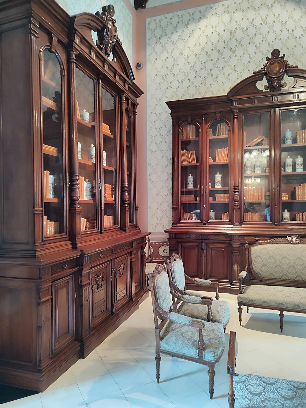 a room with a cabinet and chairs