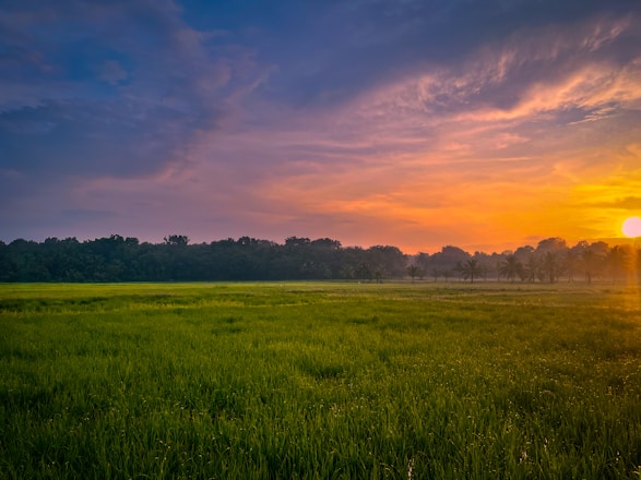 A vibrant sunset over the lush landscapes of western Cuba, inviting travelers to explore.