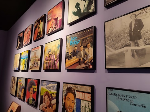 A vibrant collection of colorful vinyl album covers displayed on a wall.