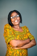 a man wearing a yellow shirt and glasses