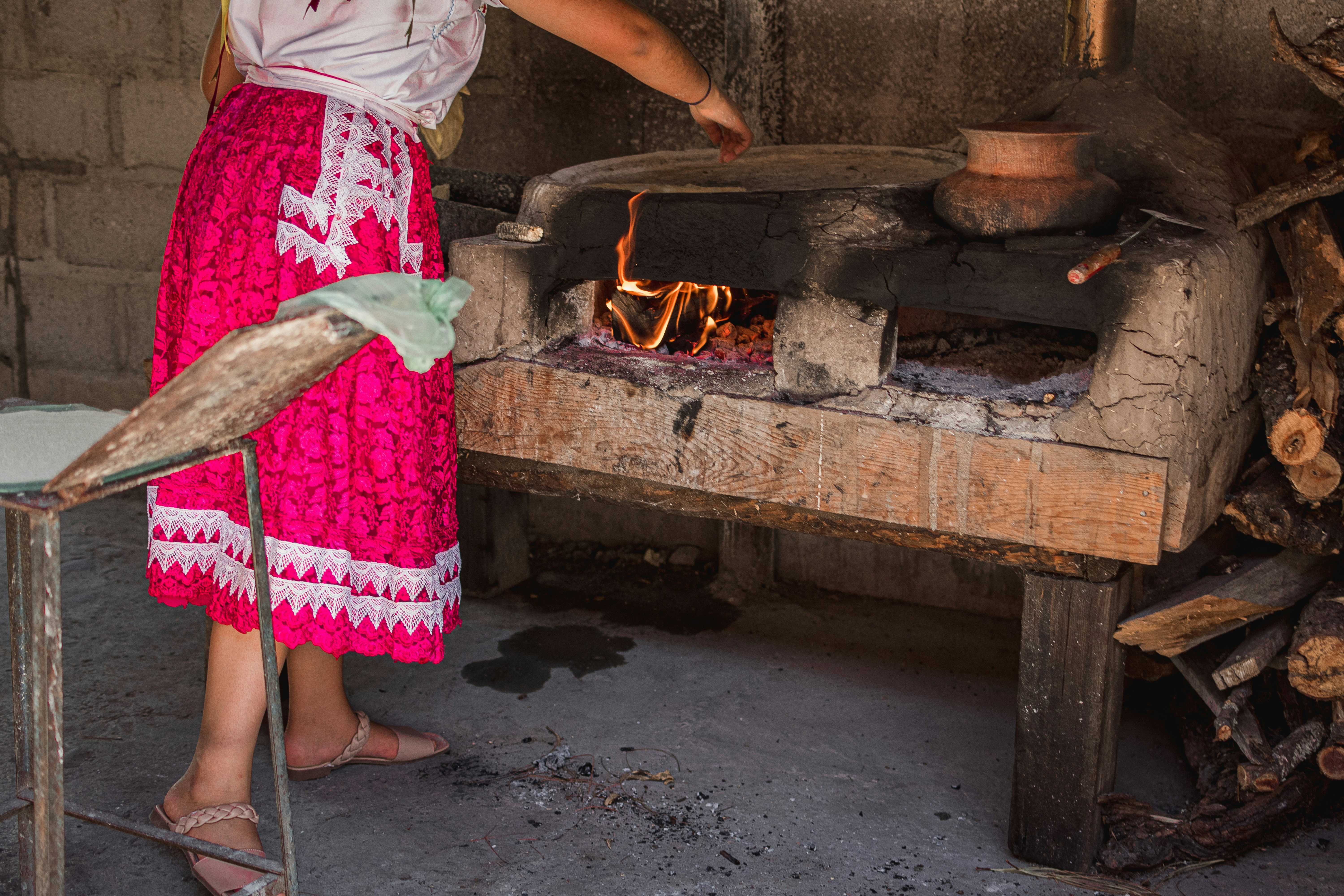 a person is cooking food in a wood stove, 