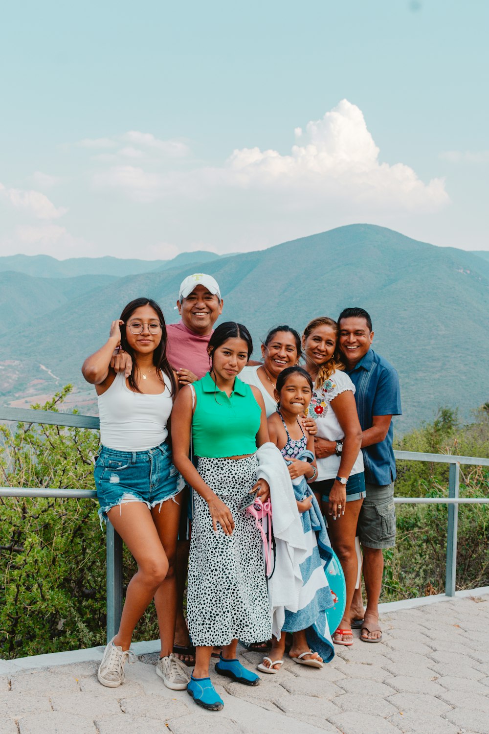 a group of people posing for a photo on a bridge