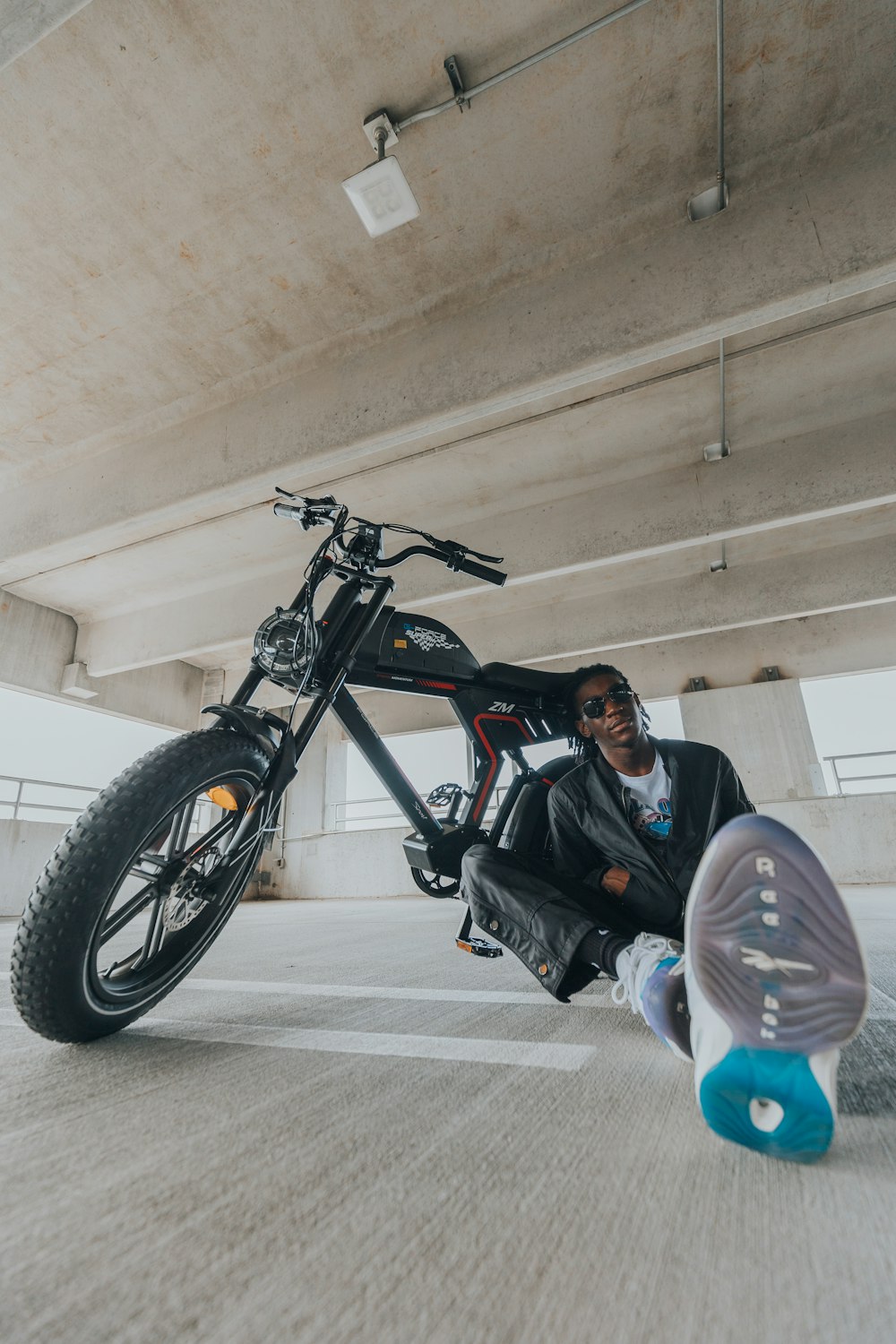 a person lying on the ground next to a motorcycle